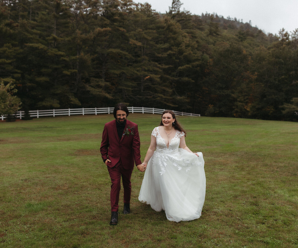 Maine couple walking in field after wedding