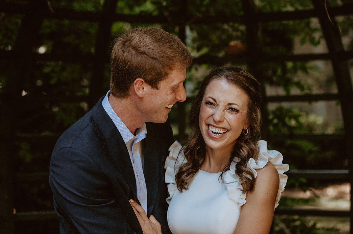 engaged couple laughs 
