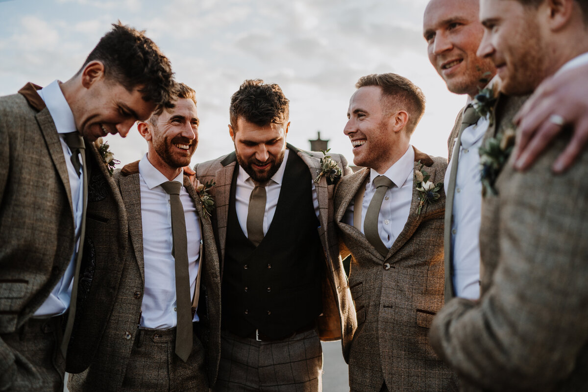 The groom and his best man share a laugh in the Glasshouse at Glenapp Castle moments before he is due to be married