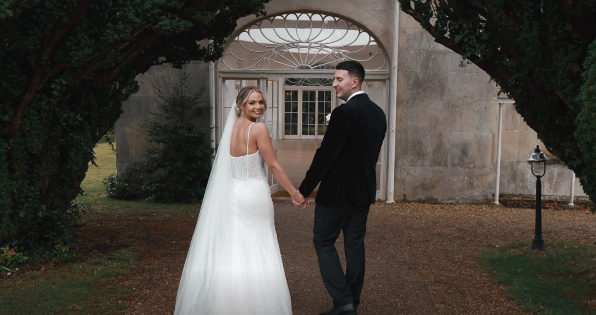 The bride and groom outside the Orangery of Northamptonshire's Barton Hall, captured on film by Northamptonshire wedding videographer HC Visuals.