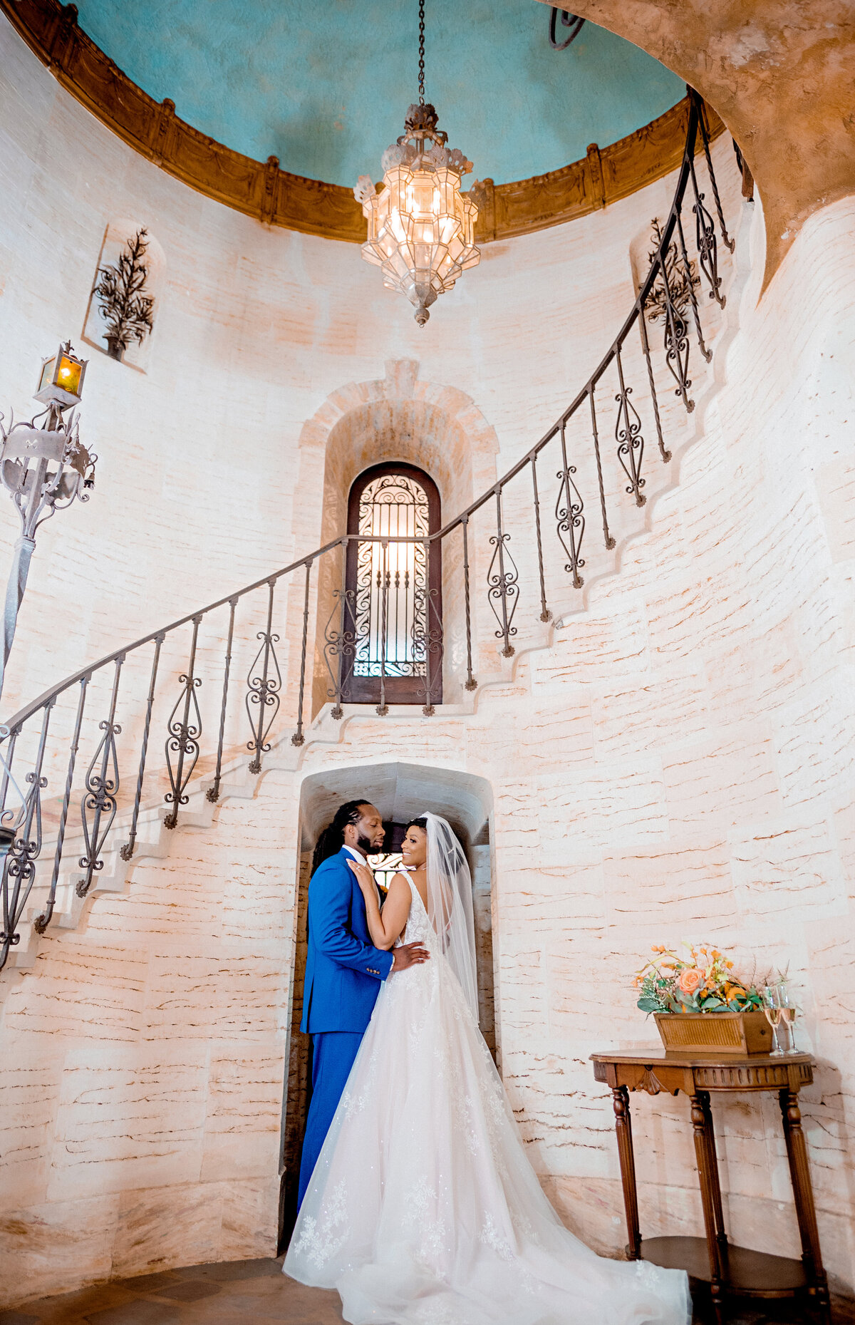 beautiful staircase and couple hugging under the stairs