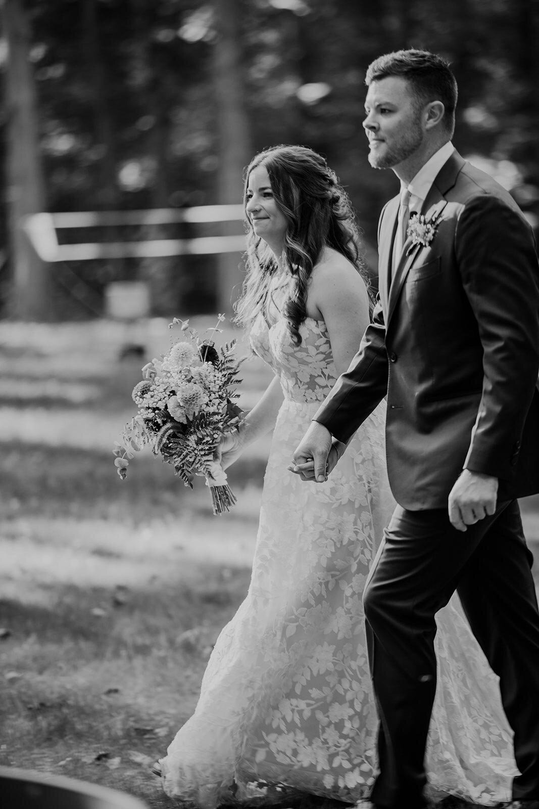 A bride and groom walking down the aisle together on their wedding day.