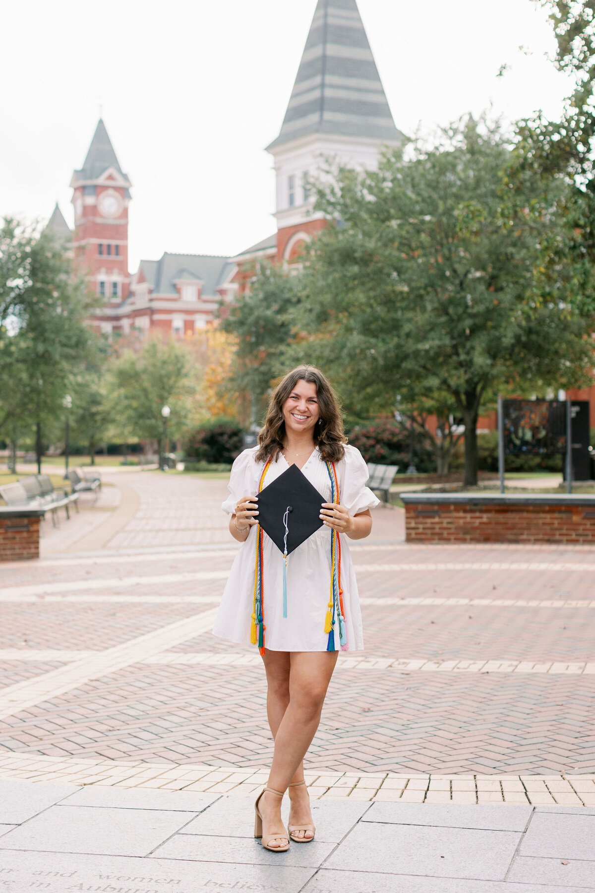 Auburn senior smiling with cap and cords