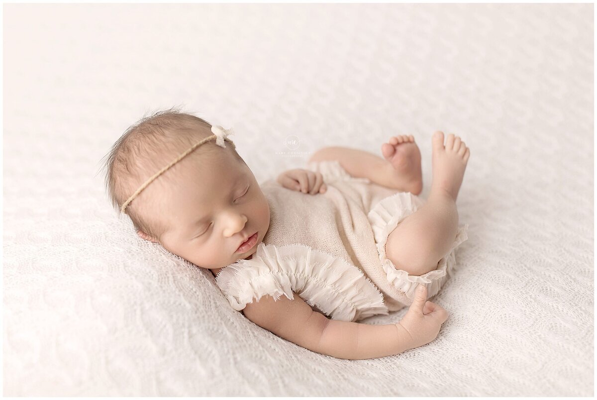 A sleeping baby in a newborn photography studio 
