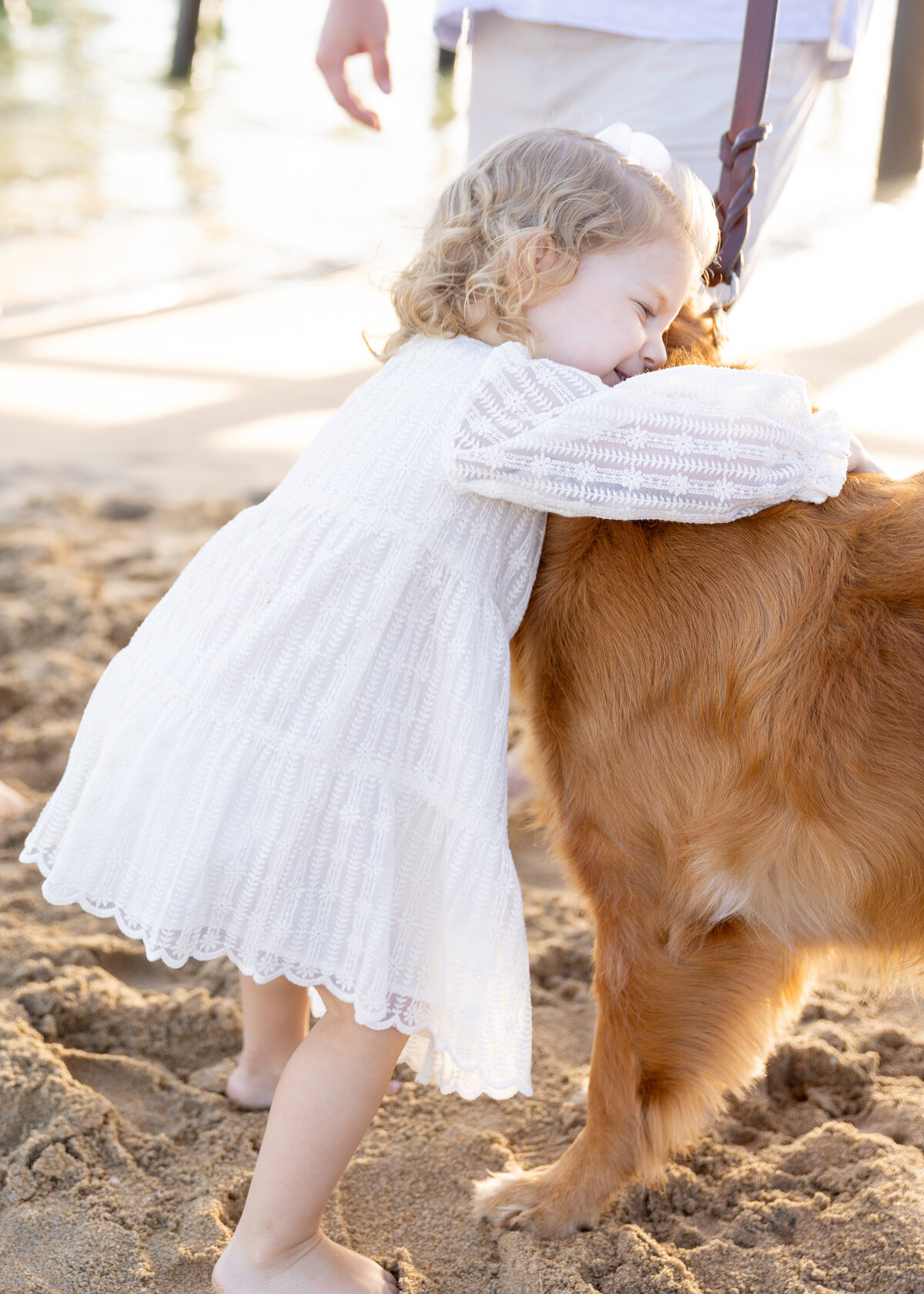 young girl hugging dog