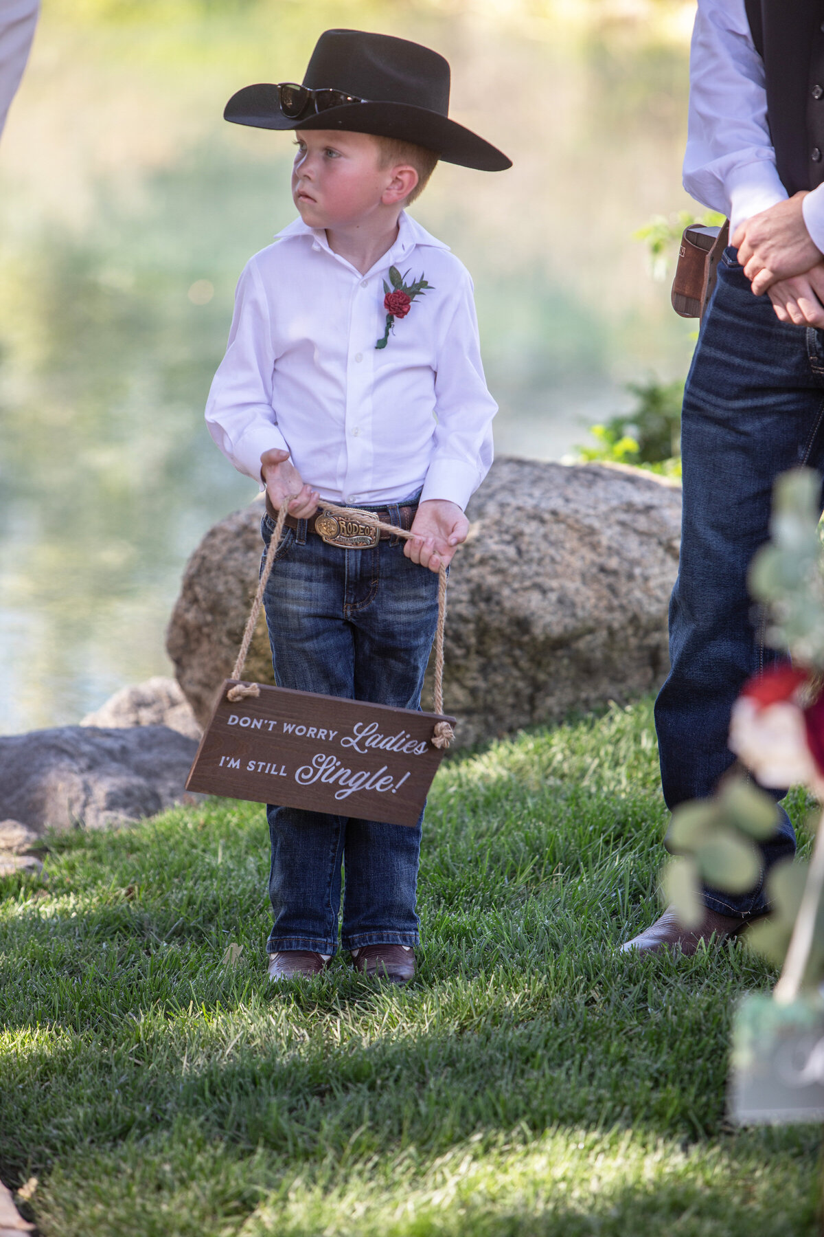 ring bearer carrying a sign