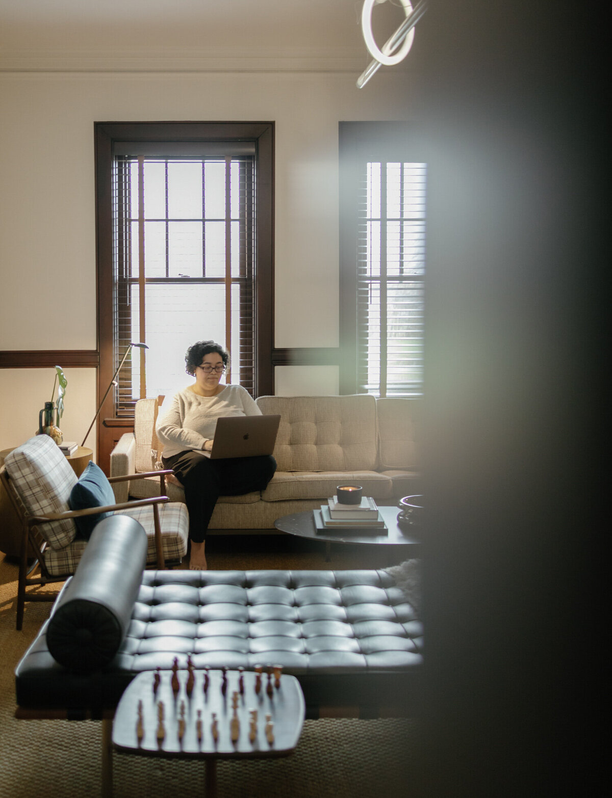 web designer works on laptop at bed & breakfast, ALEO Detroit, Little Village