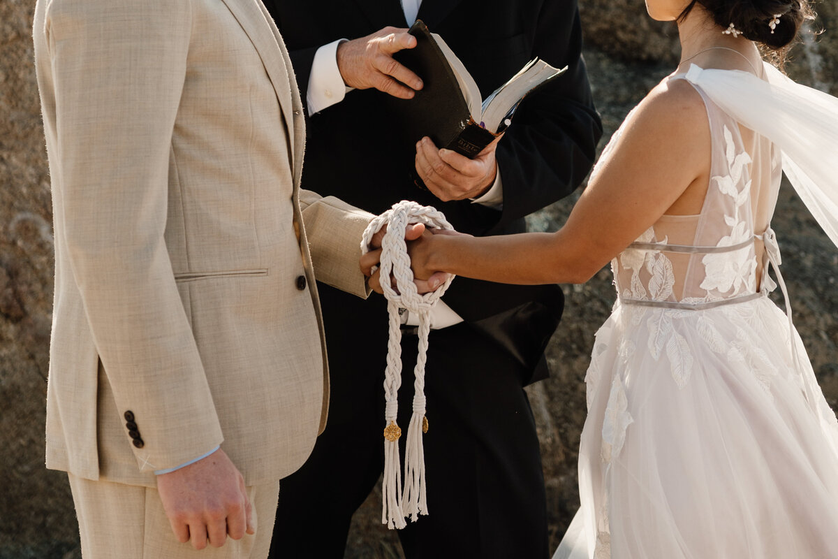 bride and groom tie knot elopement