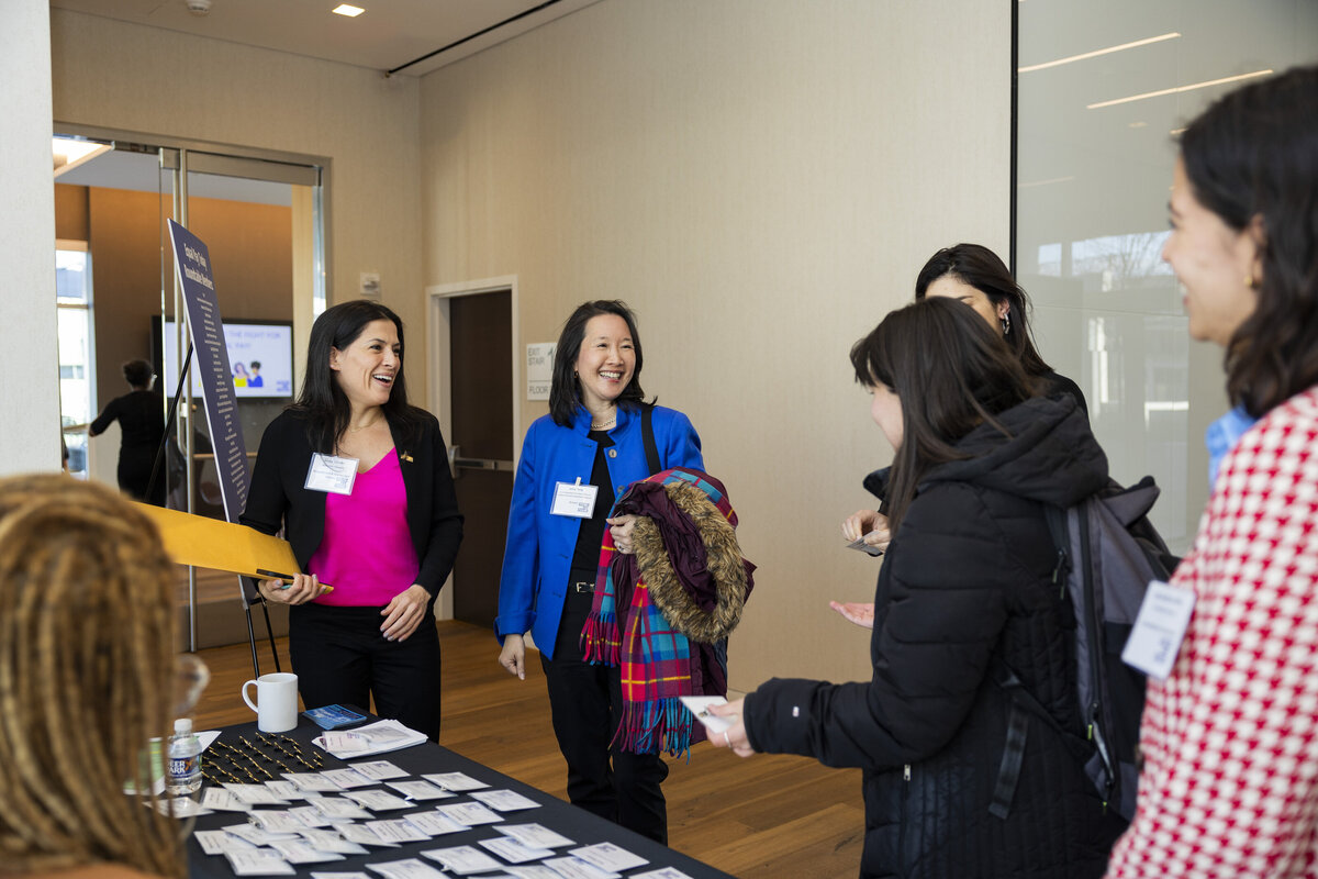 People pick up name tags at an event.