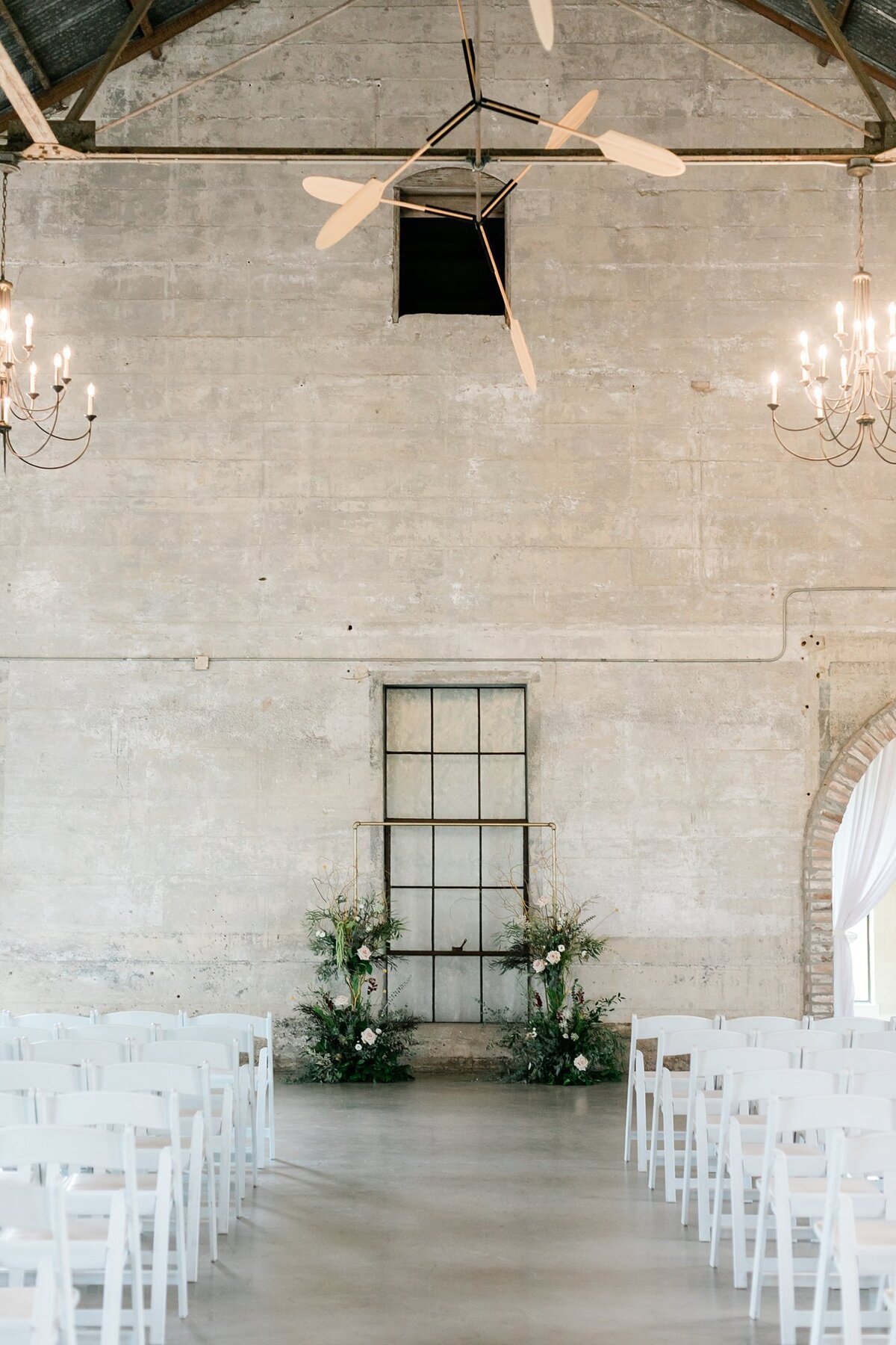 Olde Dobbin Station's chapel decorated with a greenery and floral arch backdrop for Morgan and Jimmy's wedding day.