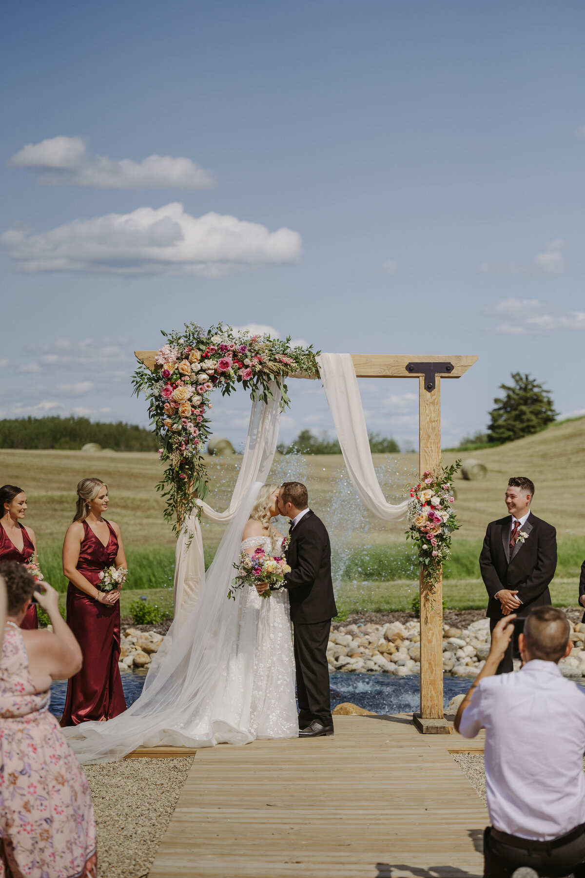 bride and groom first kiss at garden view estates