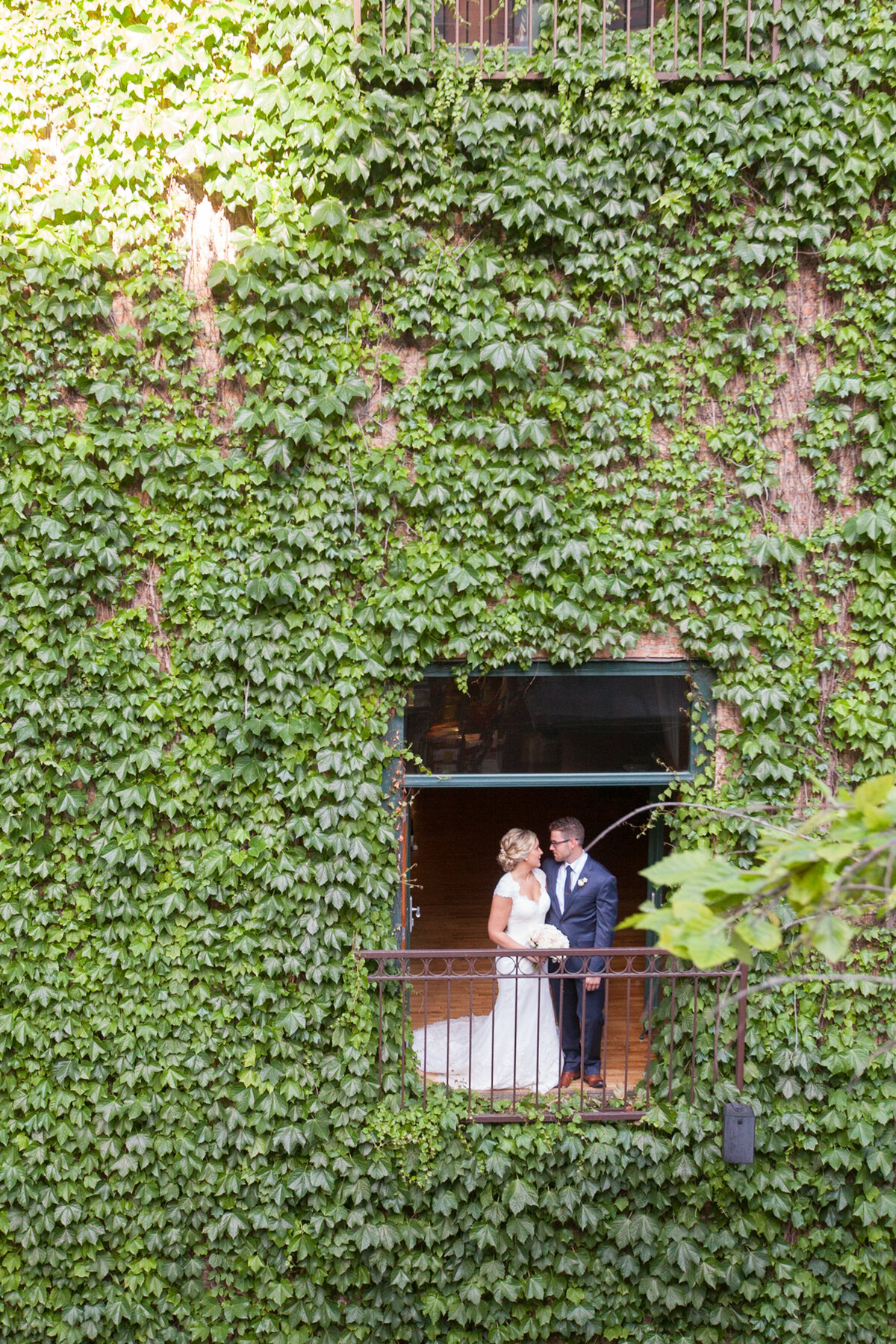 bride and groom in the windows at The Ivy room in Chicago