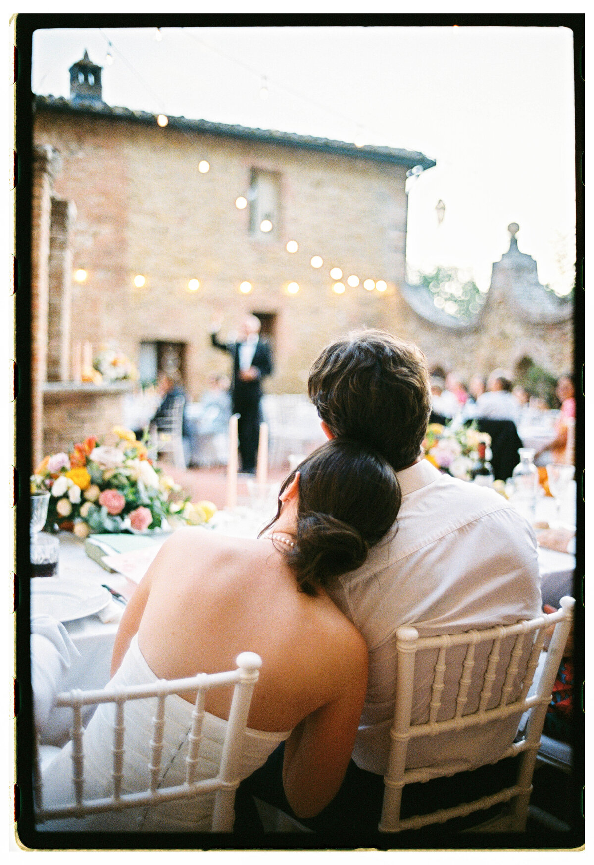 Intimate moment during Tuscany destination wedding dinner, captured on analogue film by The Falkenburgs Studio