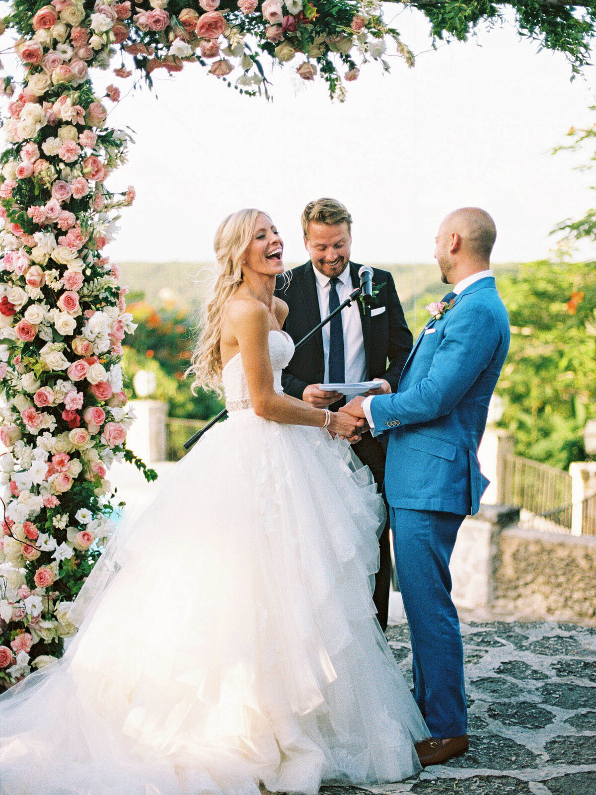 Bride and groom exchanging vows at their outdoor destination wedding