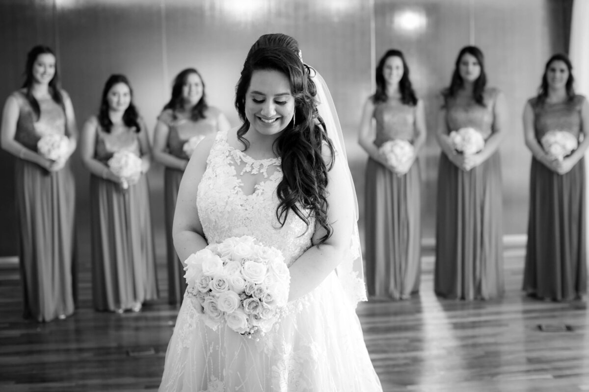 Weddings and Family Portraits in Orange County black and white photo of bride standing with bridesmaids