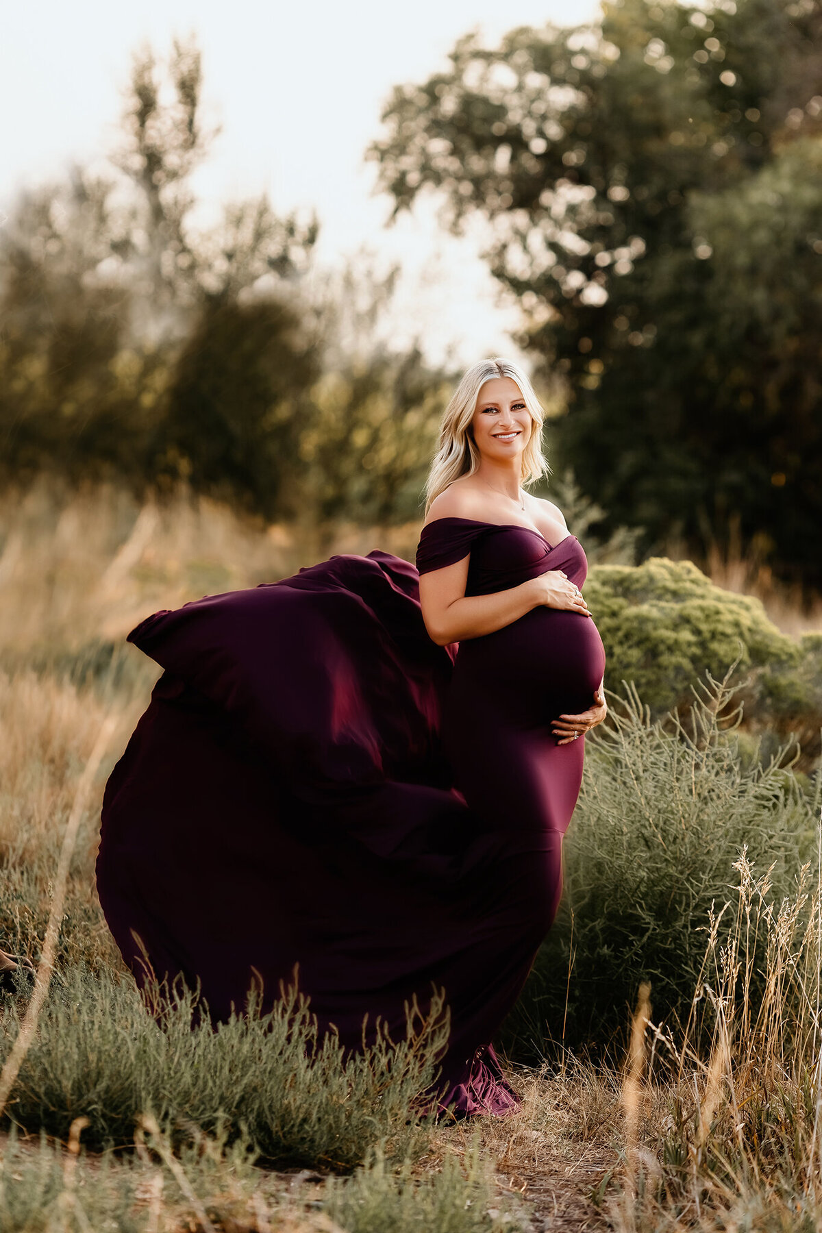 elegant maternity photos in berry gown in loveland colorado