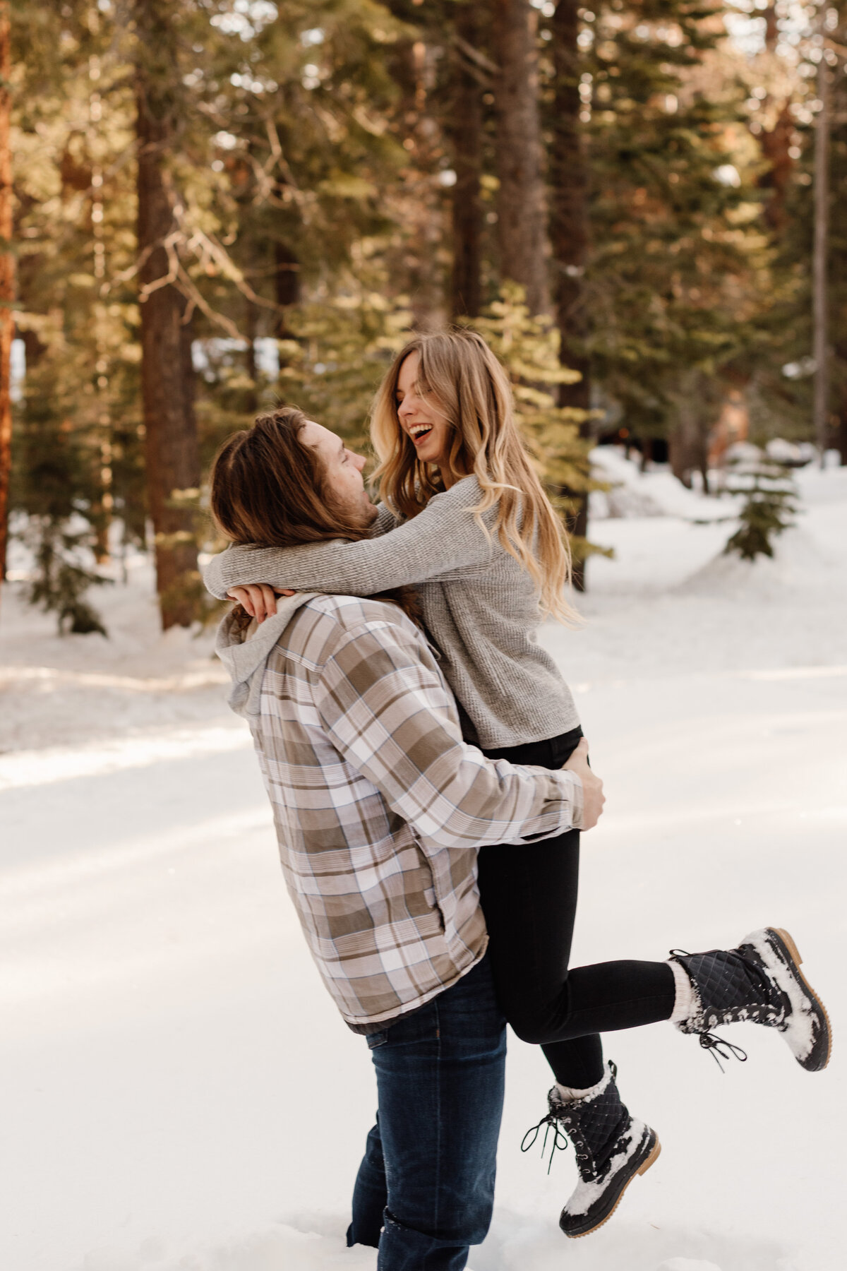 playful couple in snow in truckee