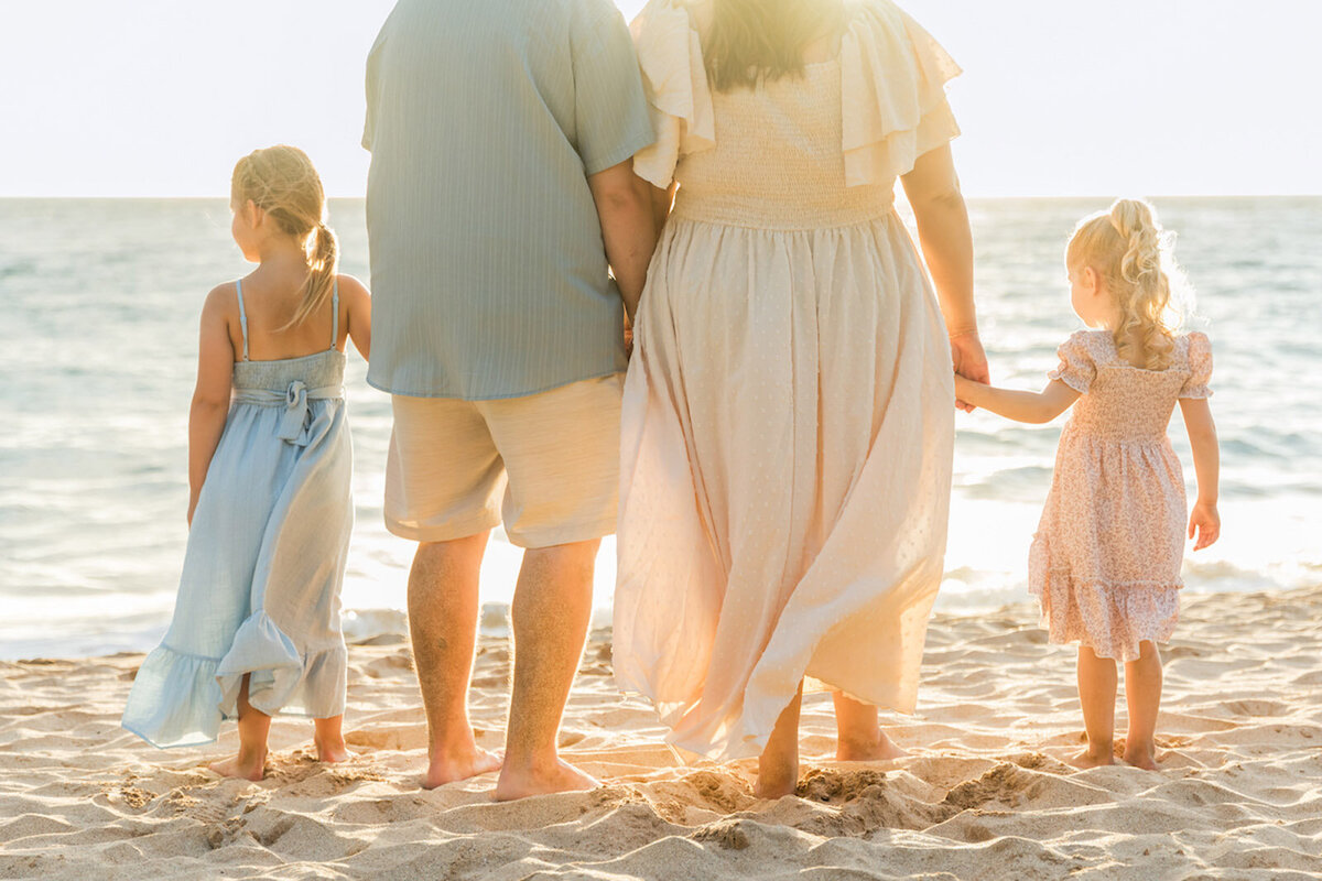Cute photo session on the beach in Maui with family holding hands