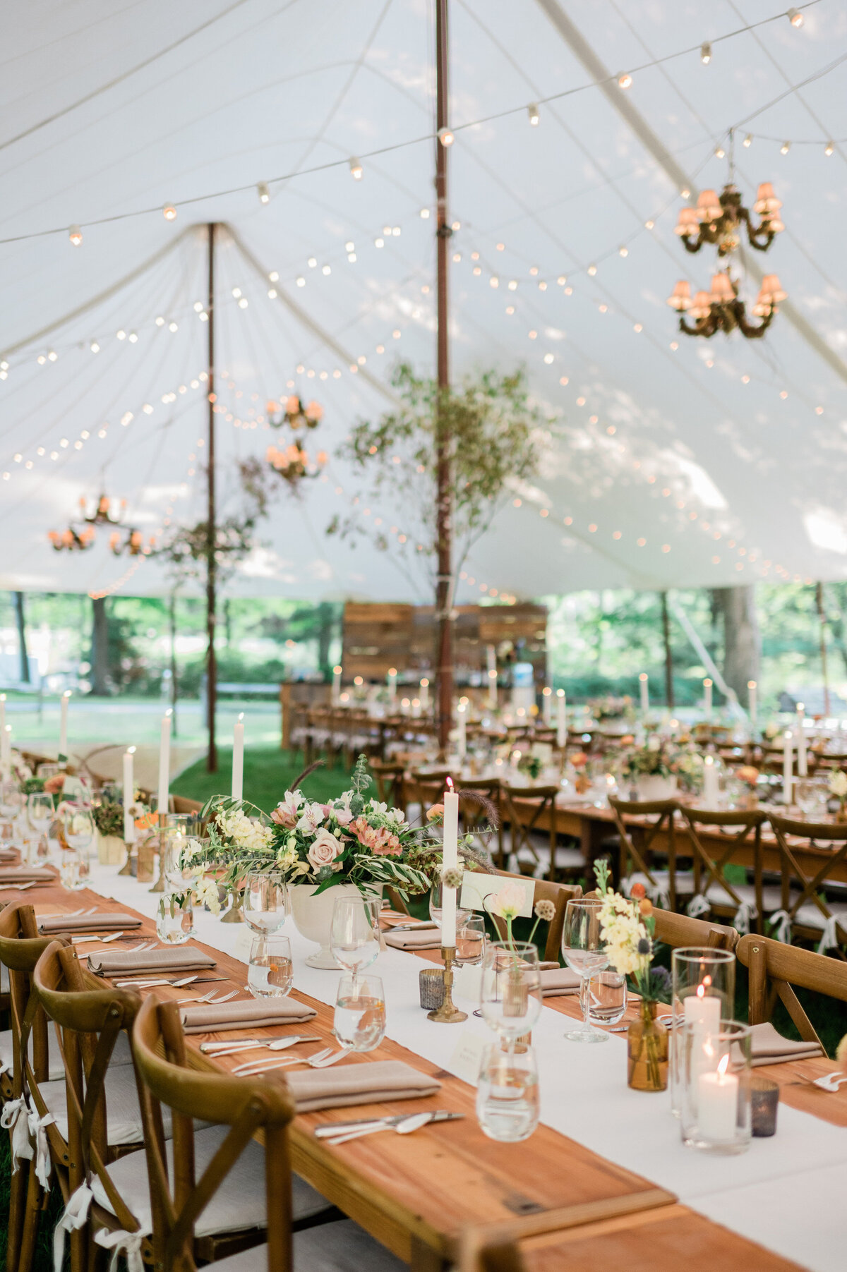 A long reception table underneath a tent