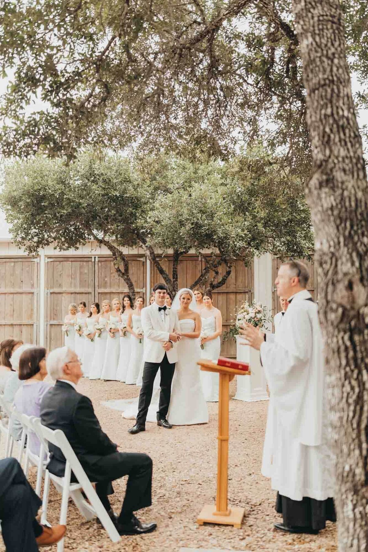 bride and groom look at pastor while he stands at his pulpit giving sermon about marriage.