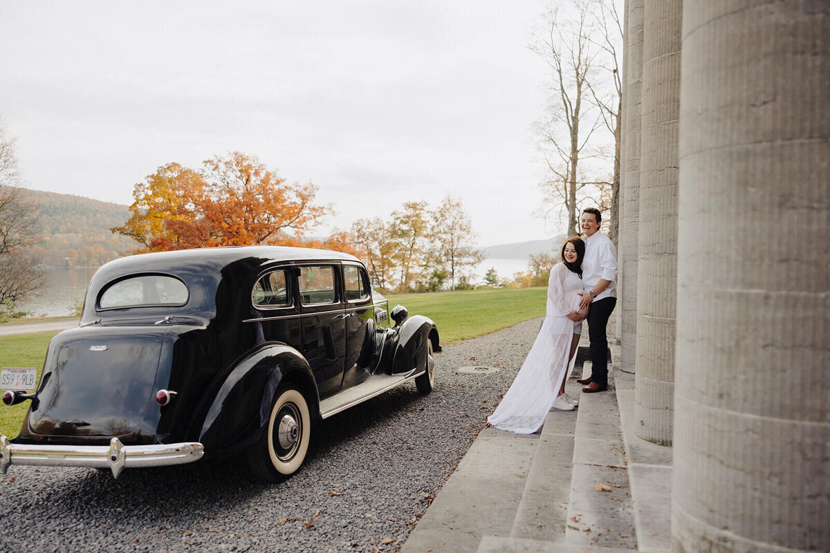 Couple sat on steps at maternity shoot in Finger Lakes, NY