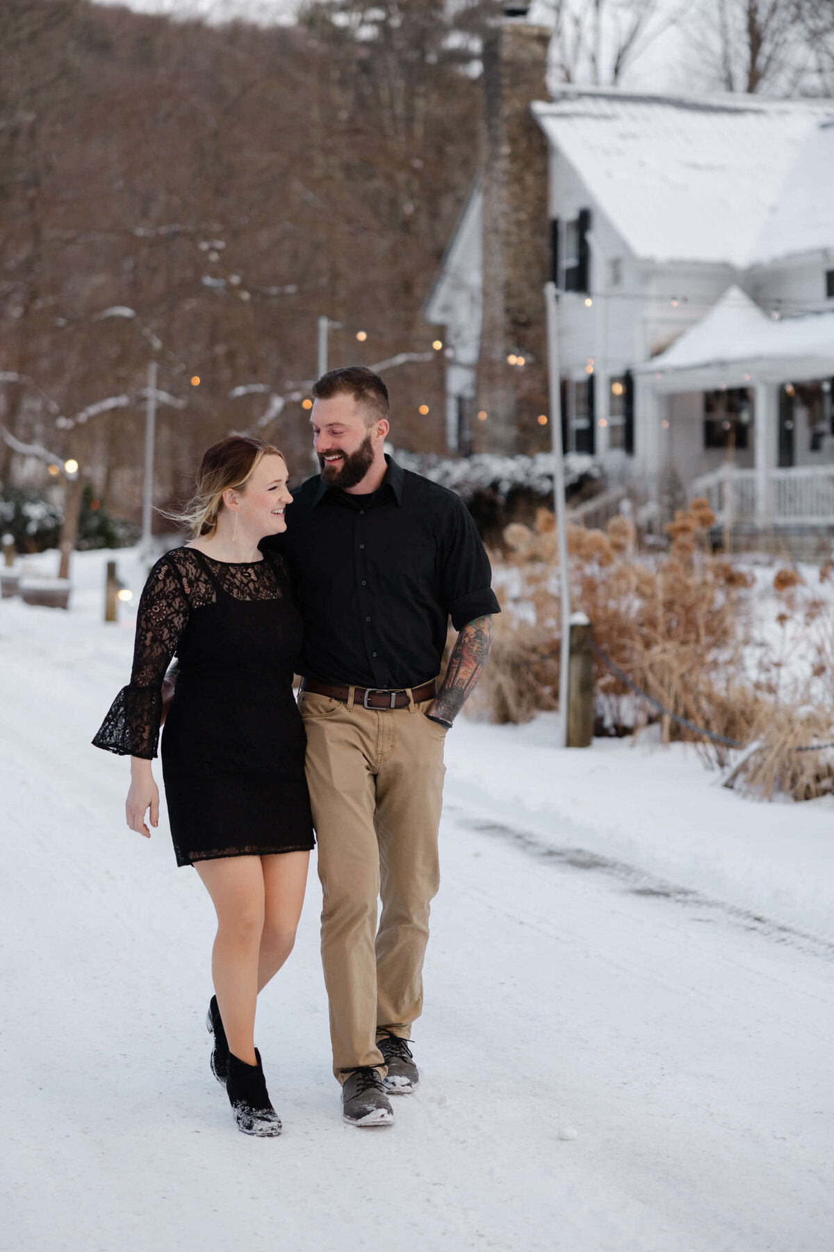 Bride and groom share a snowy intimate walk together at their intimate wedding elopement at the Tillerman in Bristol Vermont -  kristen essex fine art photograpthy