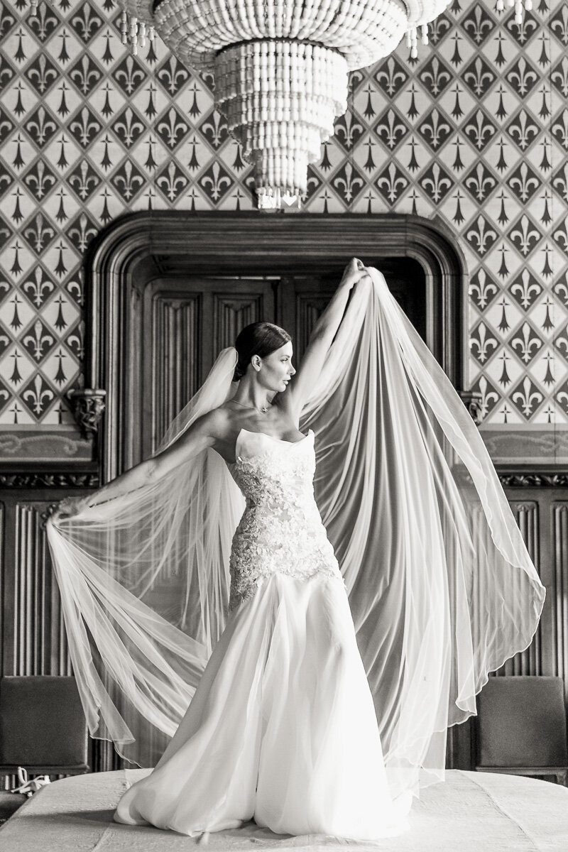 ride posing in a high-fashion, Vogue-inspired style at Château Challain, captured in elegant, natural wedding photography