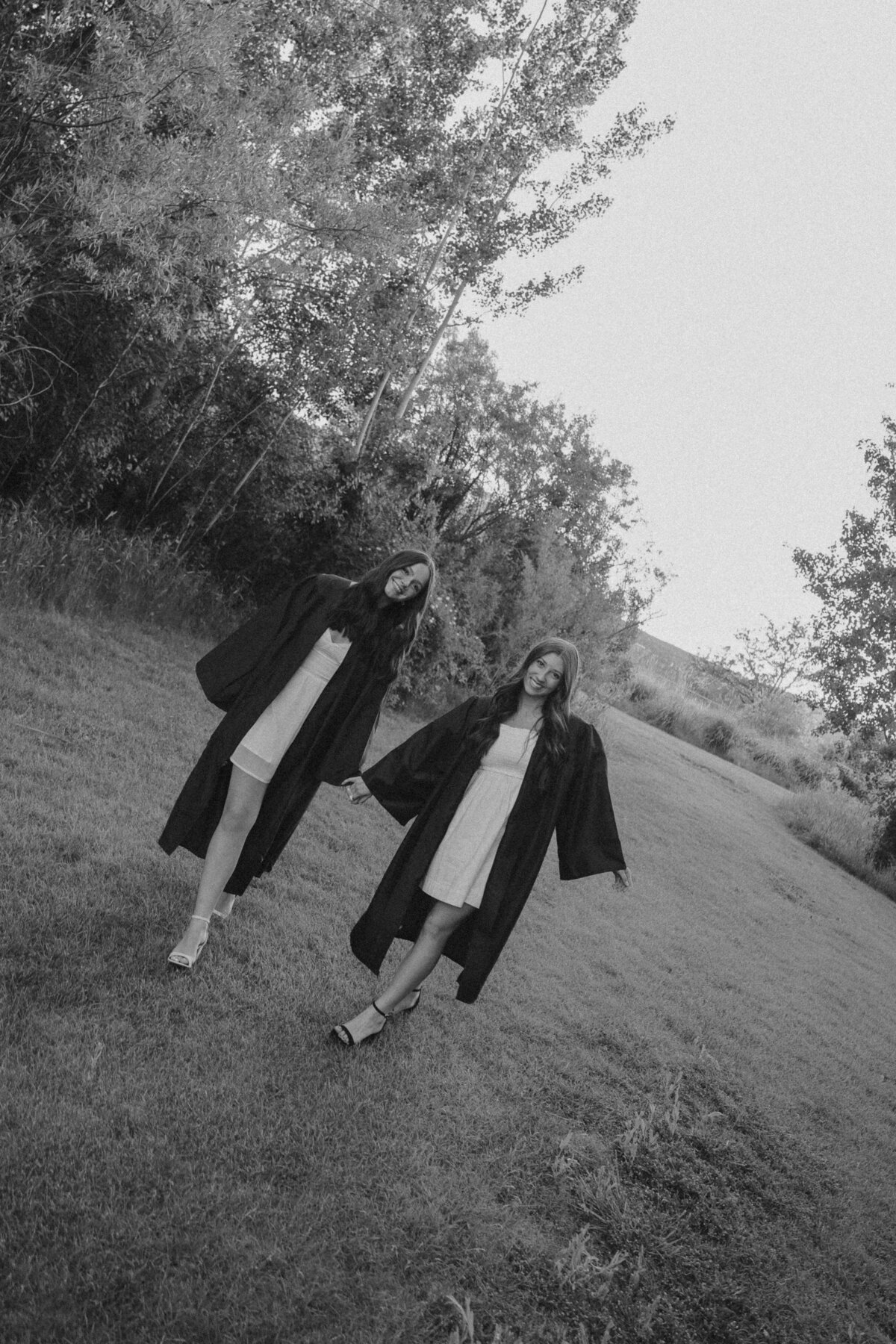 Golden Hour Senior Portrait Leaning on Wooden Fence in Meadow