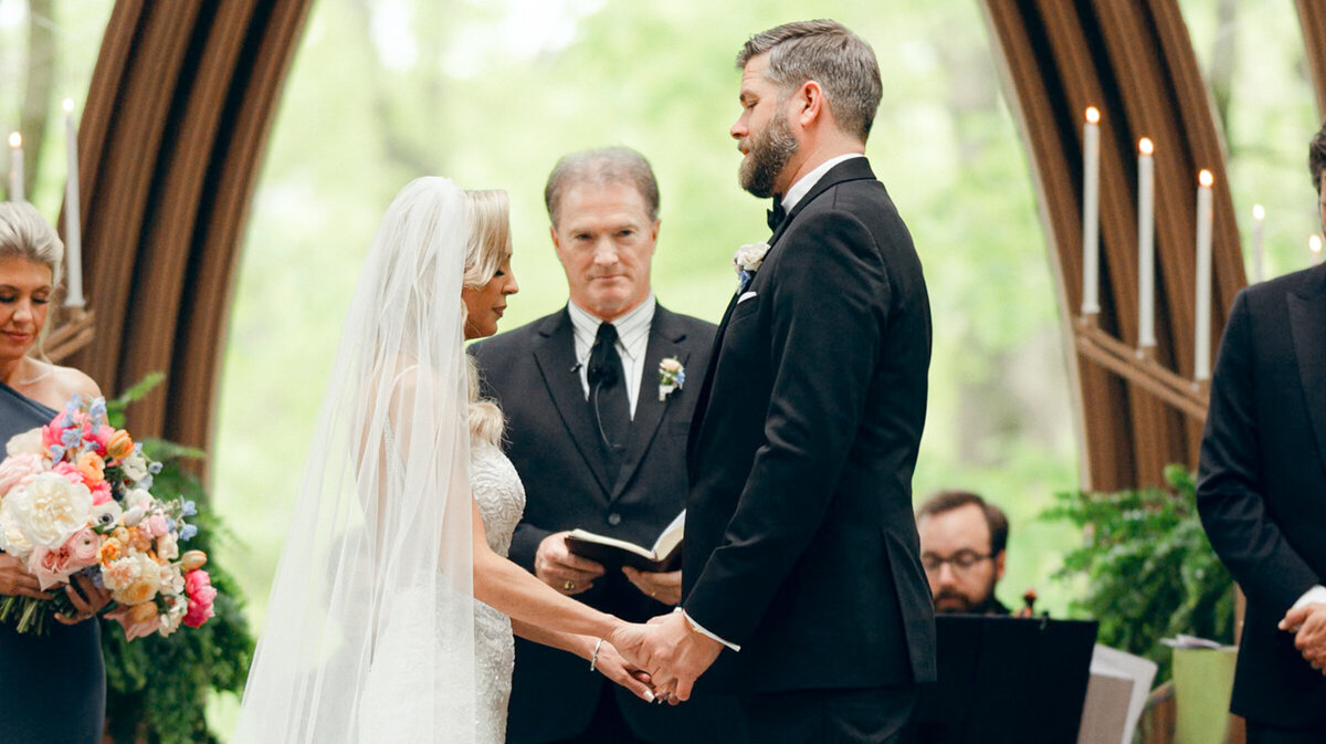 A wedding photo of the bride and groom on the alter at Anthony's Chapel in Hot Springs Arkansas