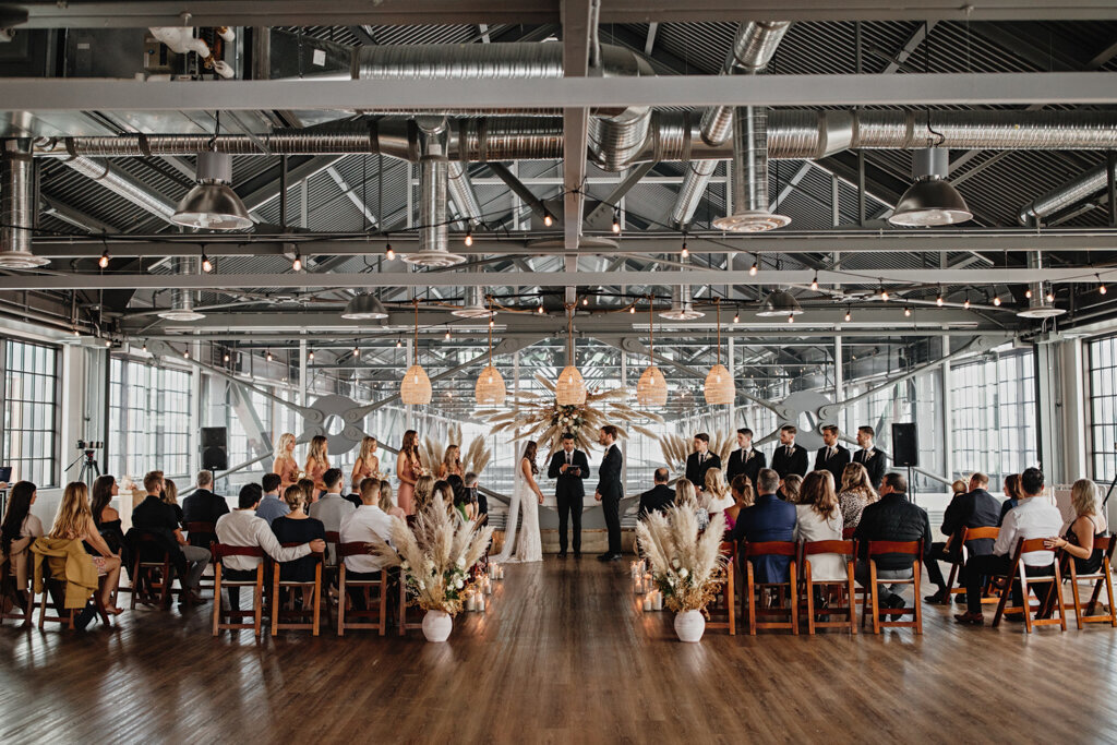 Wedding ceremony in industrial venue, The Wallace Venue, a historic venue in The Shipyards of North Vancouver, featured on the Brontë Bride Vendor Guide.