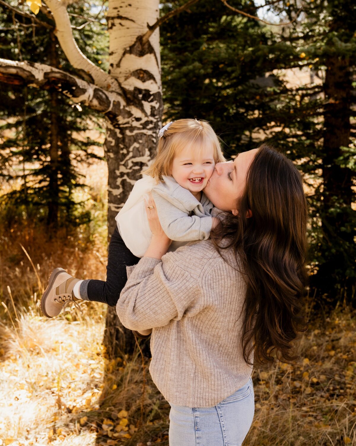 mother kissing young daughter's cheek