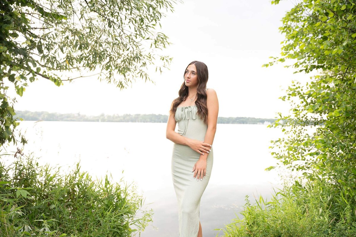 Senior-girl-posed-by-lake-in-summer