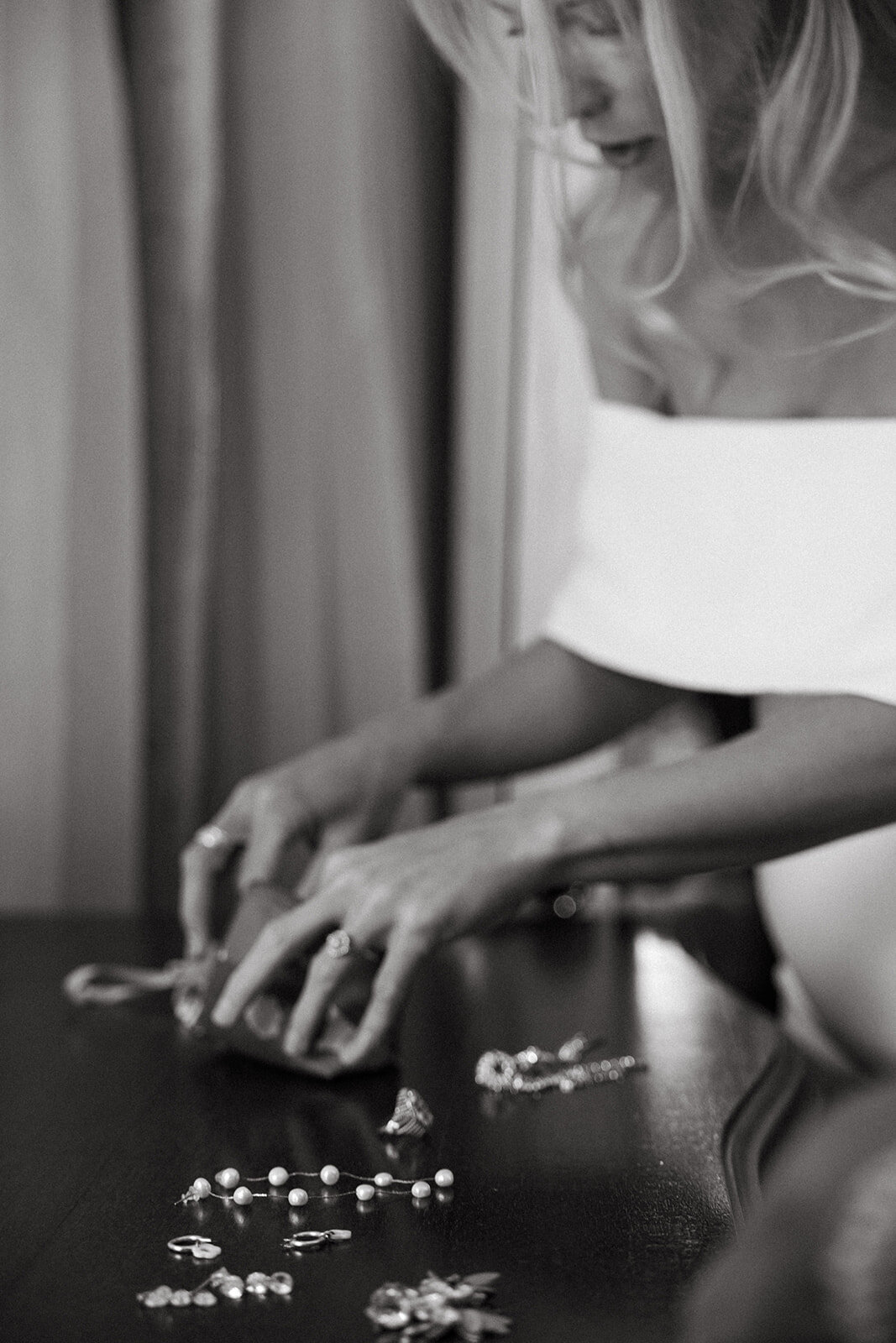 bride looking through her rings and earrings