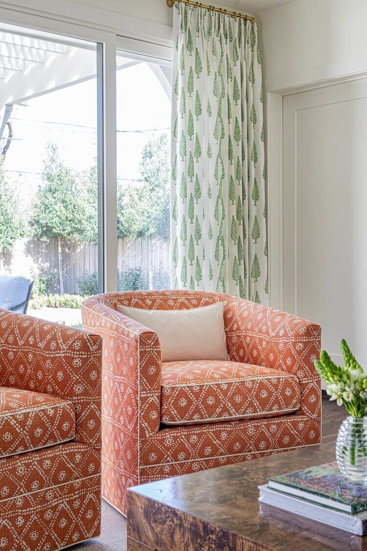 oyster creek studios highland park home red patterned chairs in living room with green curtains