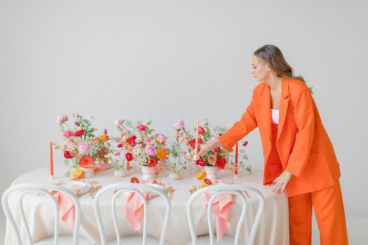 wedding planner and floral designer  setting a bold and bright wedding table