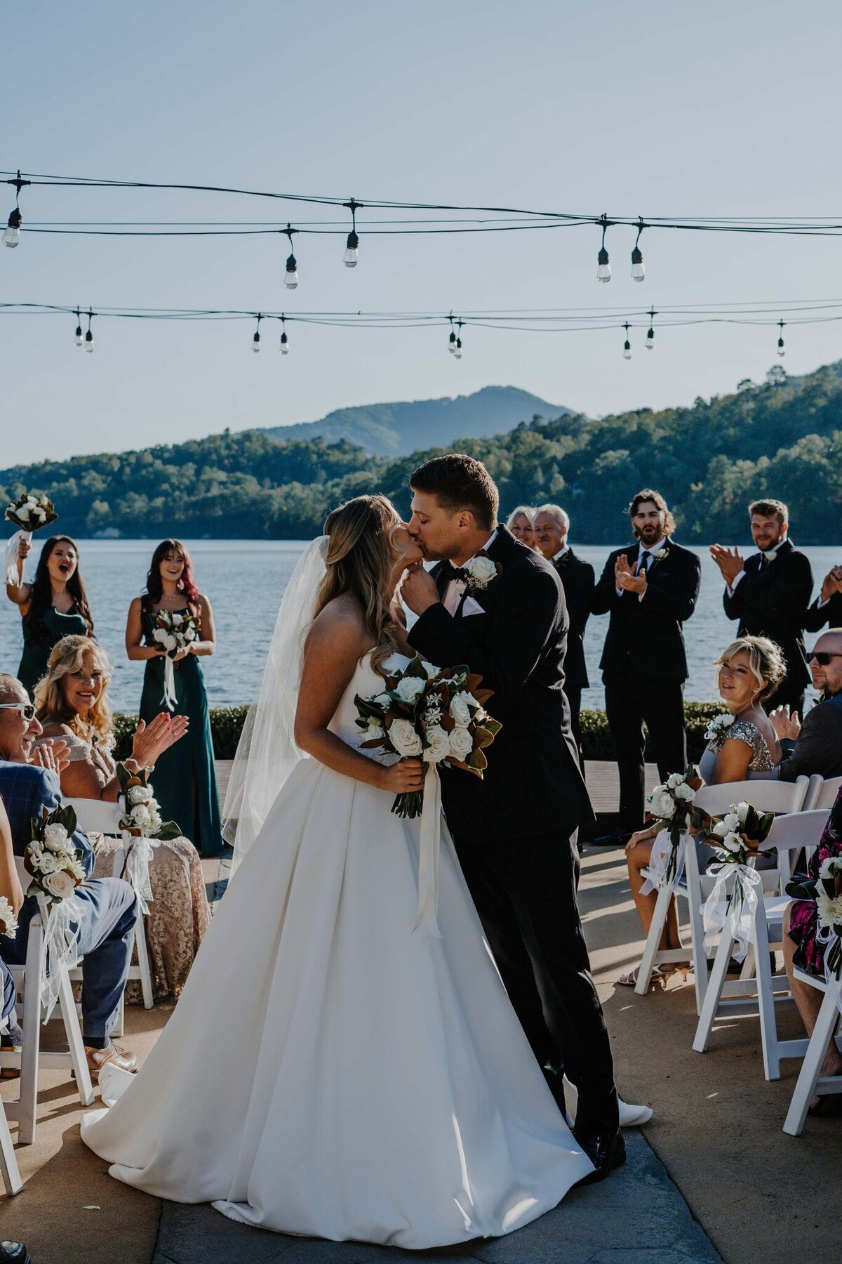 couple stopped in middle of isle kidding after being married at lake lure