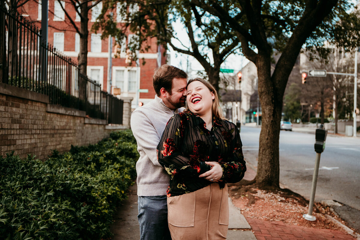 newly married couple laughs together in downtown birmingham alabama