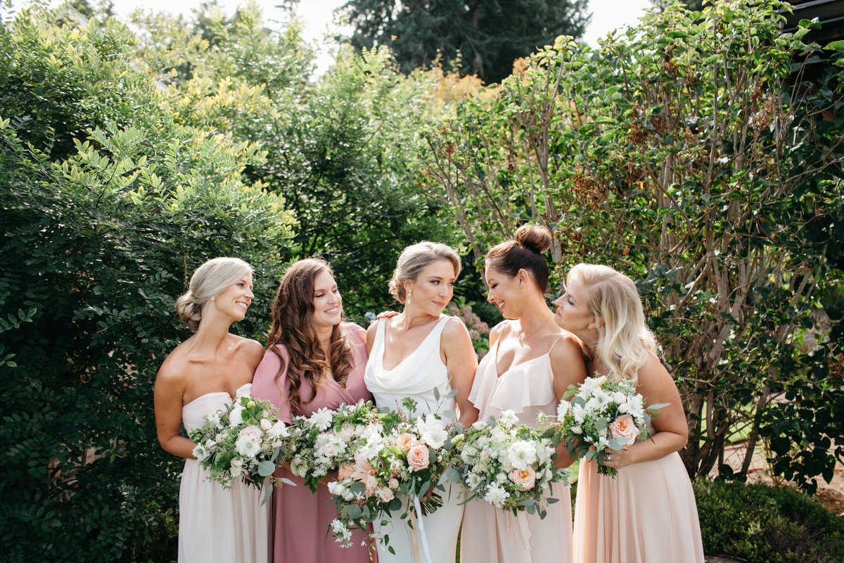 Stunning bride Anne with her bridesmaids all dressed in shades of pink with blush floral.