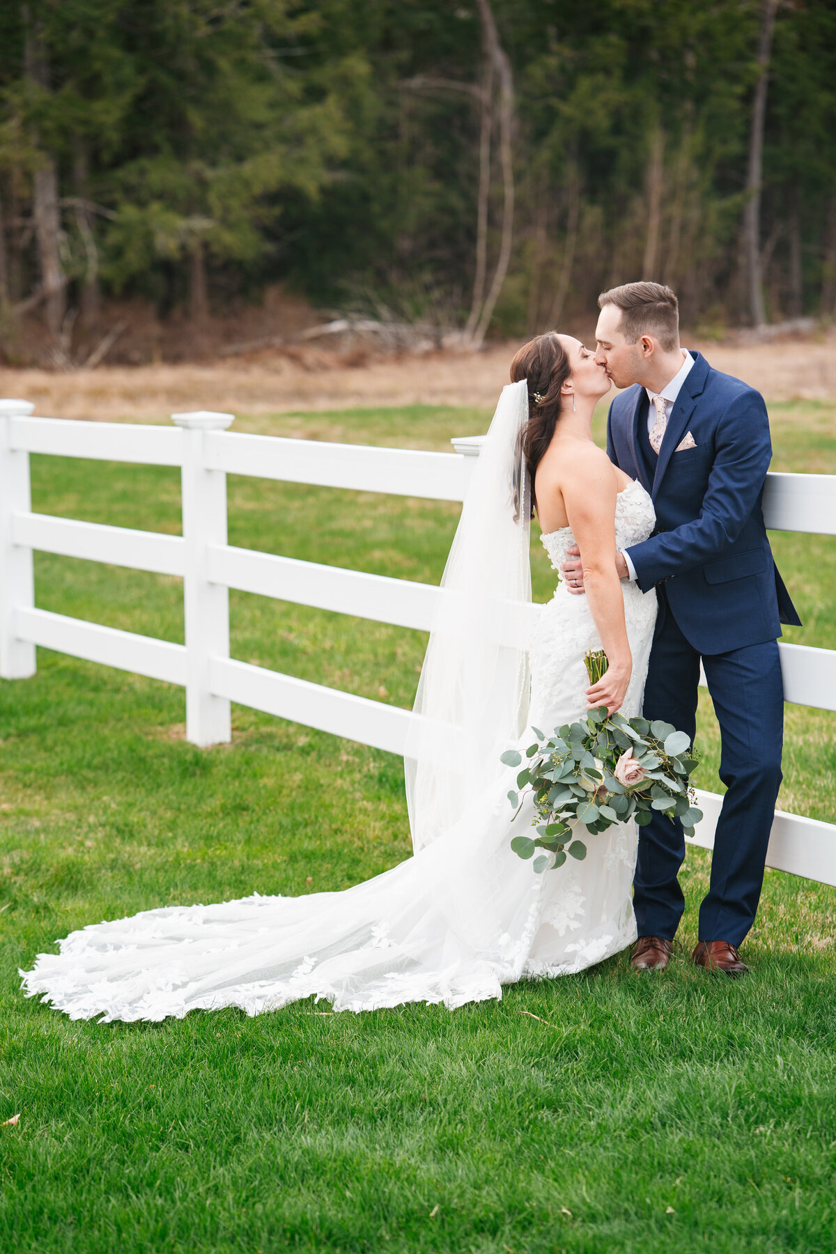 Couple exchanging vows under a floral arch in New England