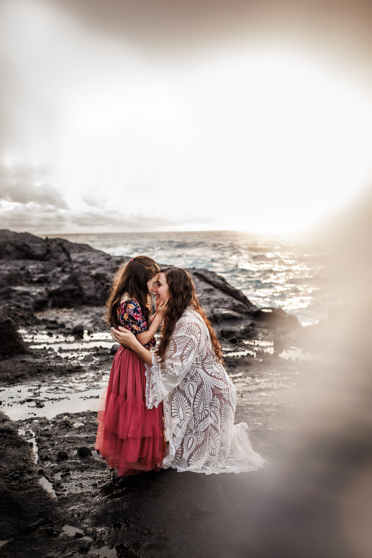 mother and dauther touching foreheads