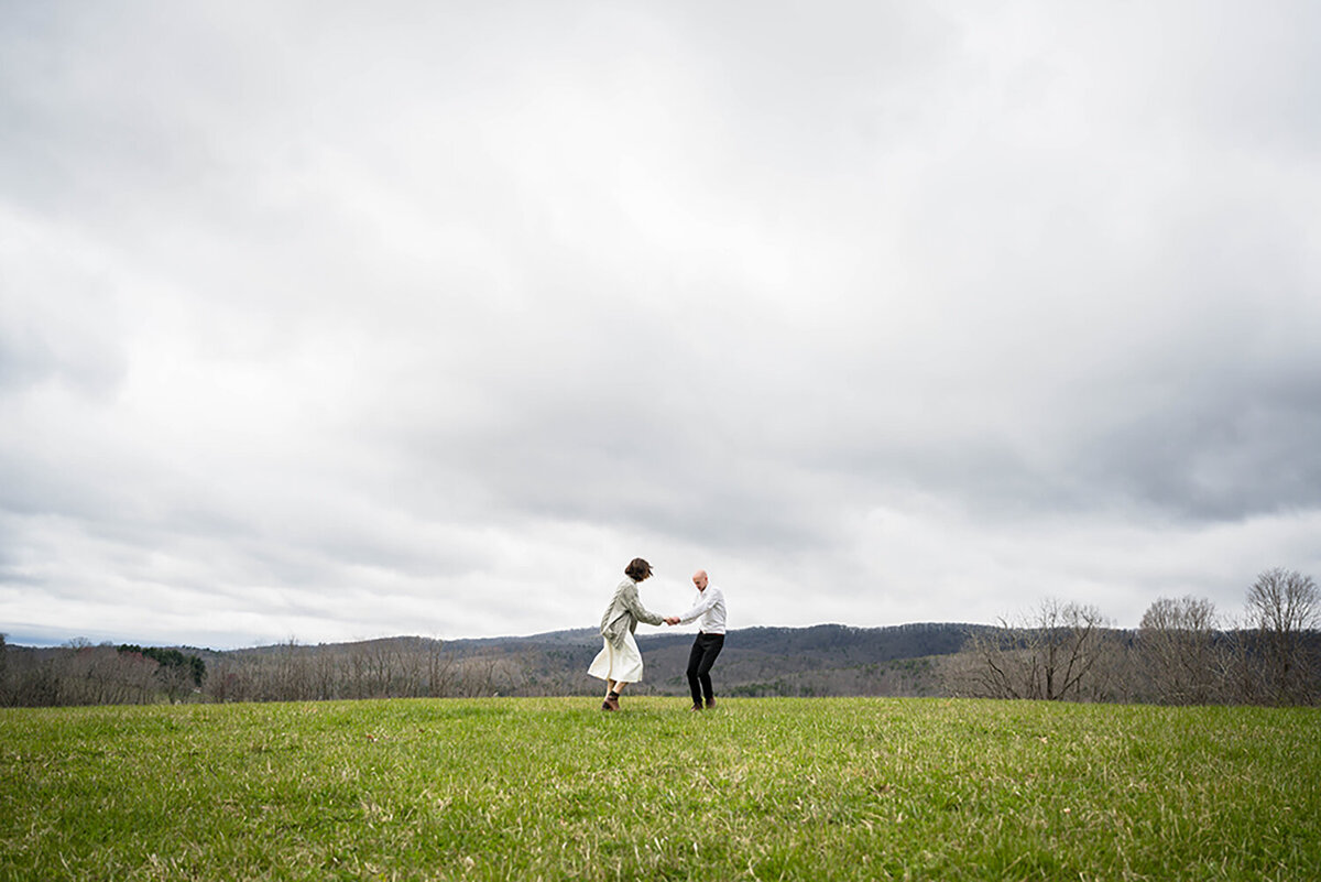 A couple dances atop a hill at Heritage Park in Blacksburg, Virginia on their elopement day.