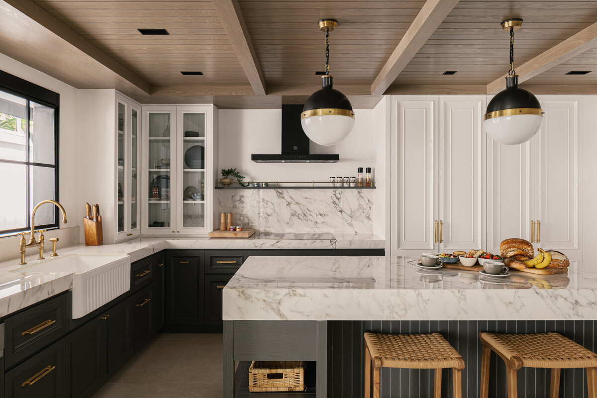 Kitchen with sink, island table and stools