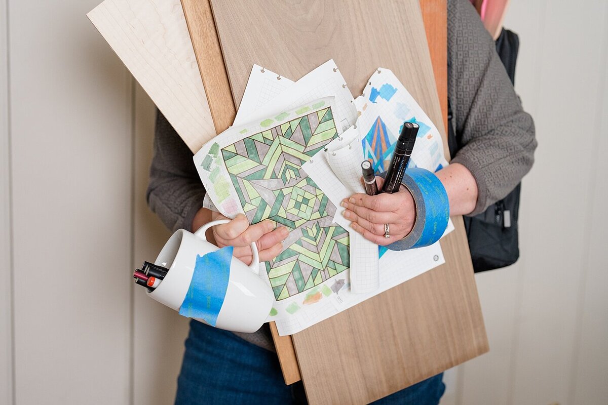 Columbus photographer captures designer branding photos with person holding design boards, tapes and pens