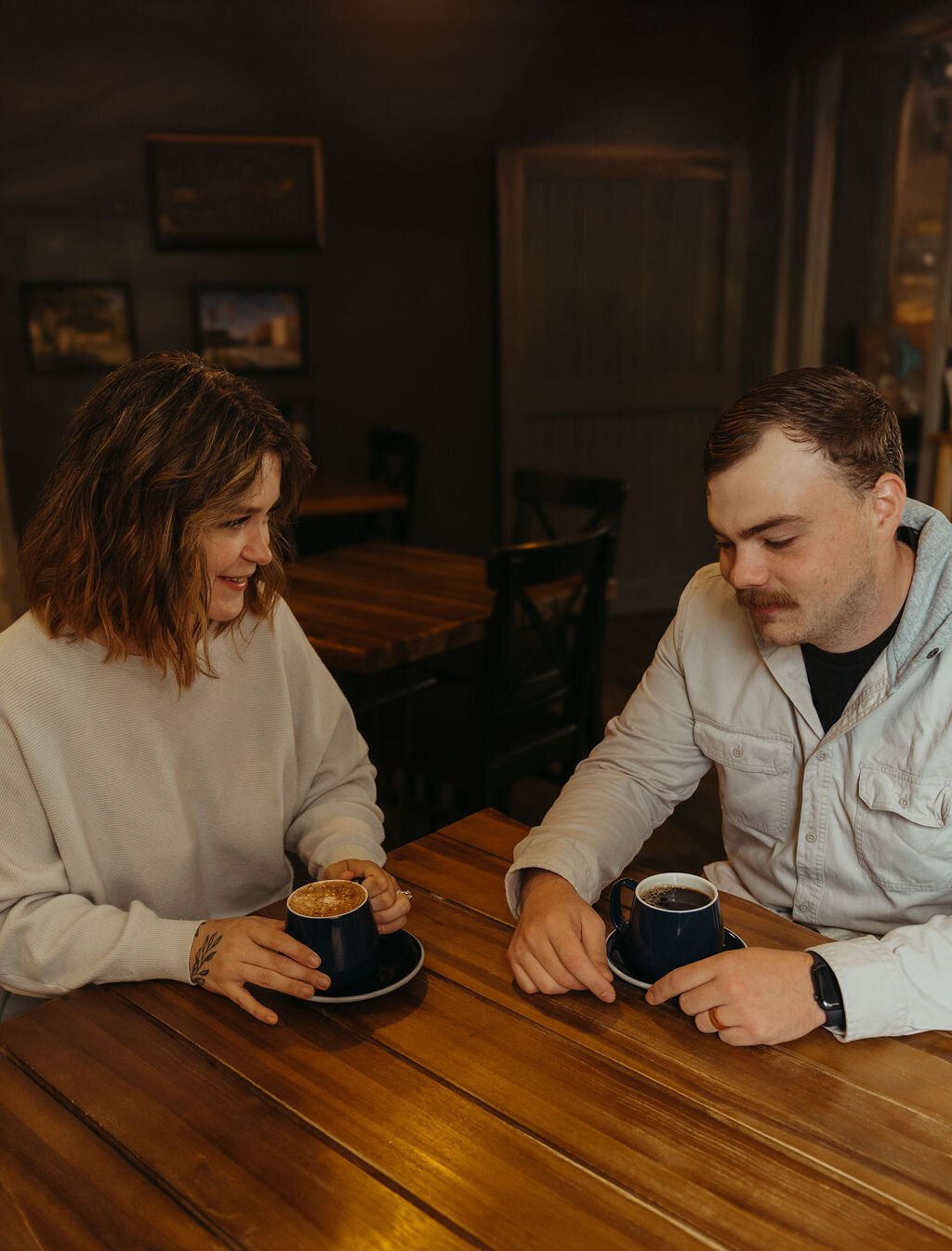 Candid photo of couple talking over coffee