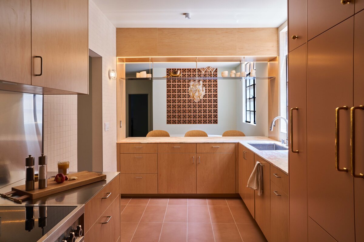 Southern California kitchen remodel galley kitchen renovation modern organic kitchen design Norwegian Rose marble countertop maple plywood kitchen cabinets stainless steel floating shelf porcelain 2x2 mosaic tile Saltillo breeze blocks modern kitchen storage solutions SoCal interior design organic modern kitchen kitchen design with natural light thoughtful floor plan edits custom pullout pantry contemporary galley kitchen