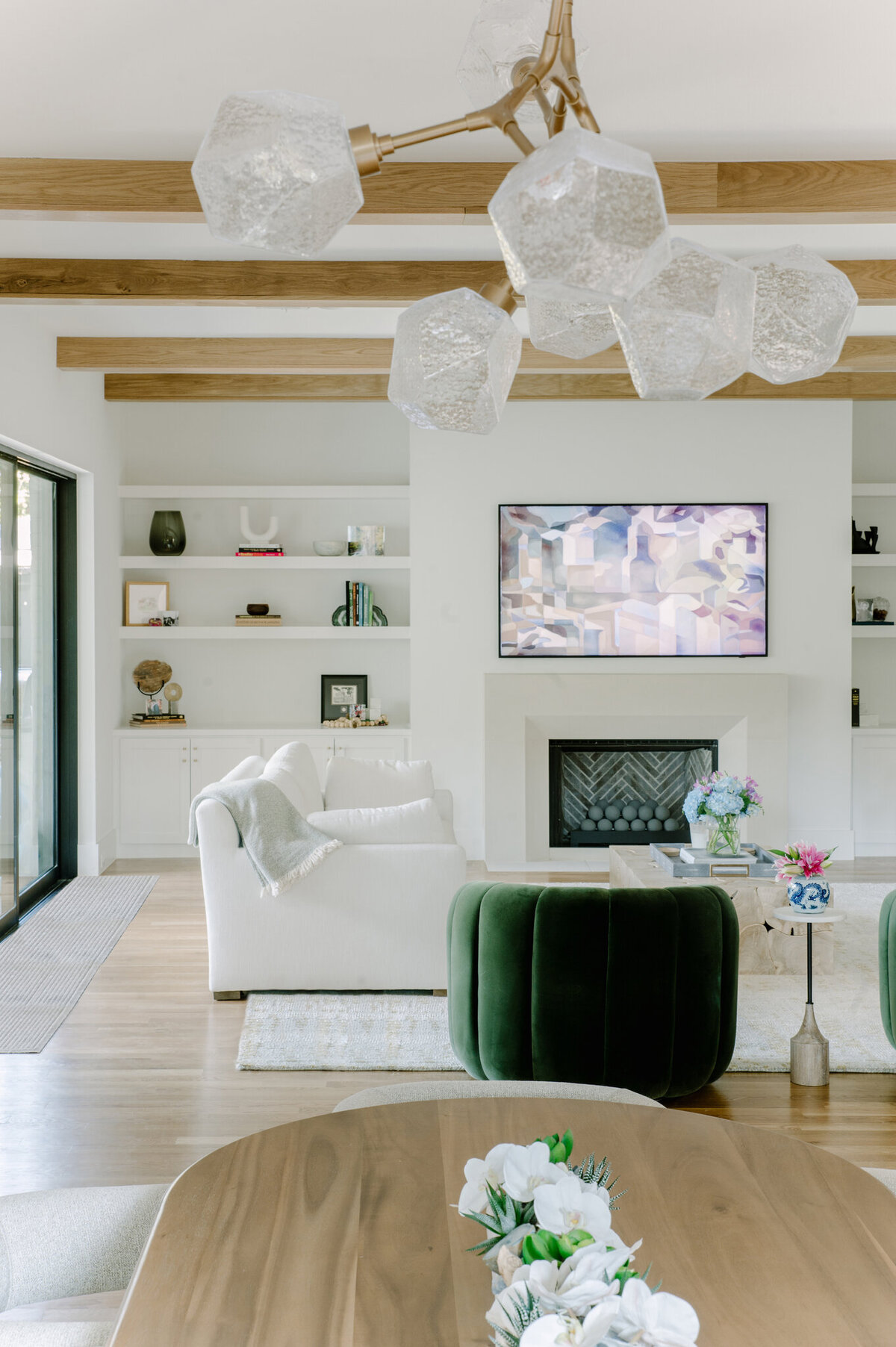 Living area of a Dallas luxury home with white walls and modern  chandelier