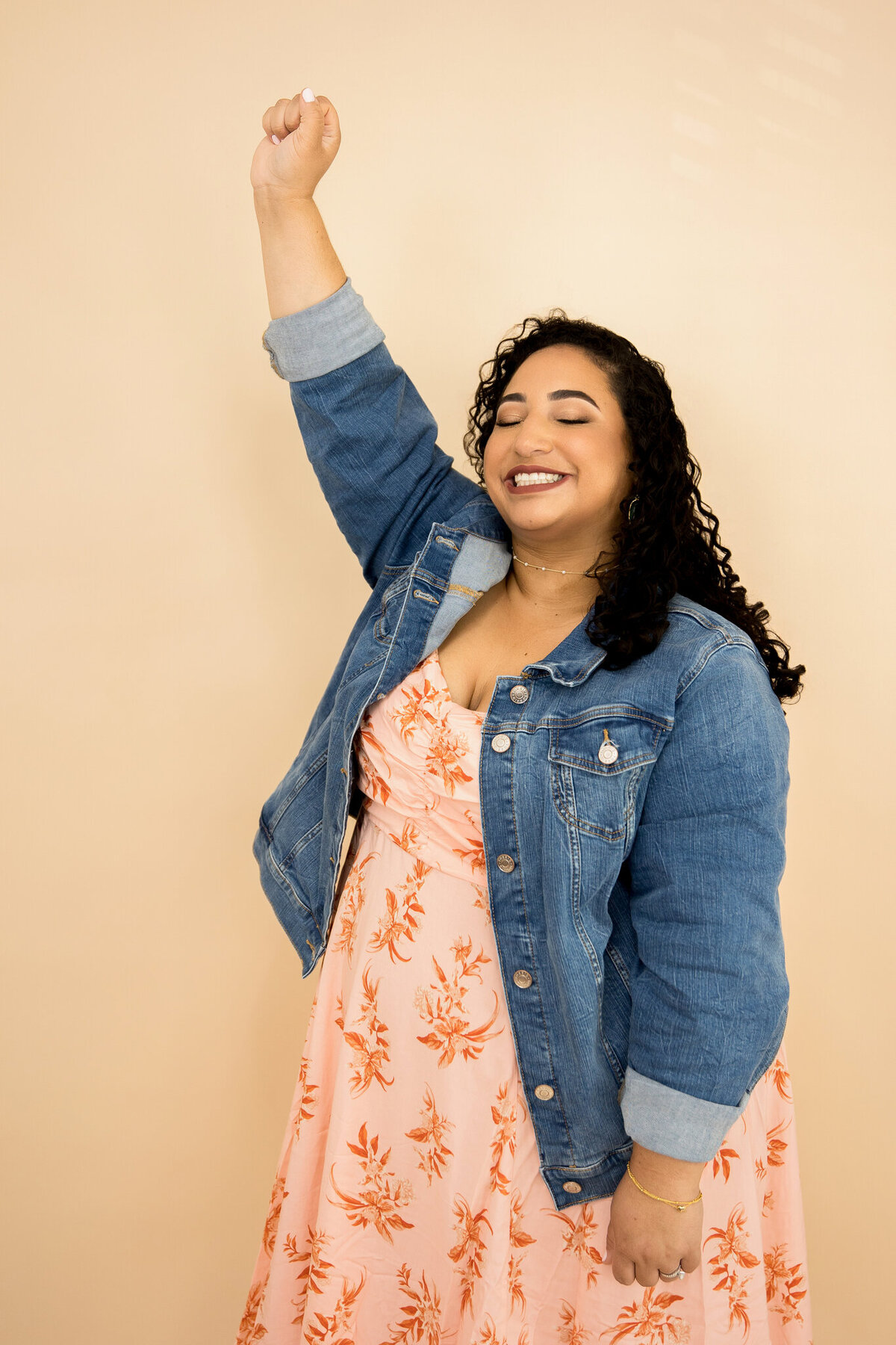 Heather’s personal branding photo with an arm raised and eyes closed highlights joy and introspection.