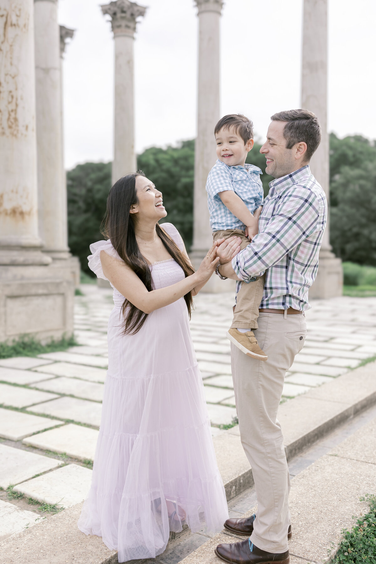 Mother and father holding son smiling in Washington DC