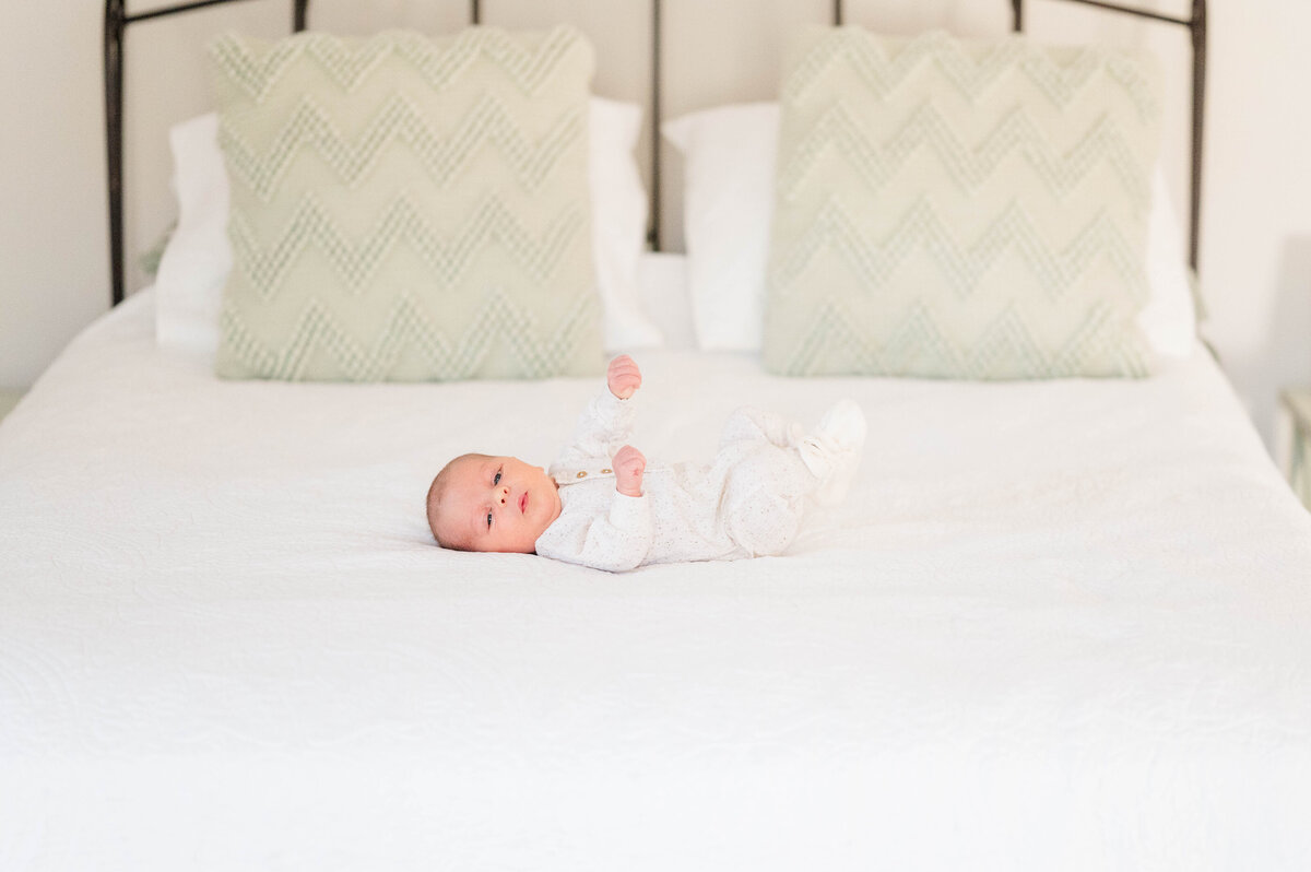 newborn baby on bed taken in Sutton, MA 