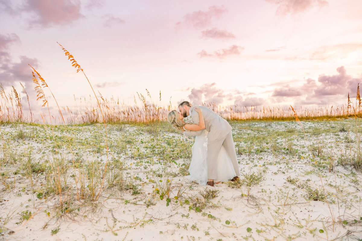 Sunset photo of bride and groom at private beach wedding in Pensacola Beach, Florida